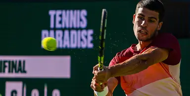 Tennis player hitting a backhand shot during a match at 2025 French Open
