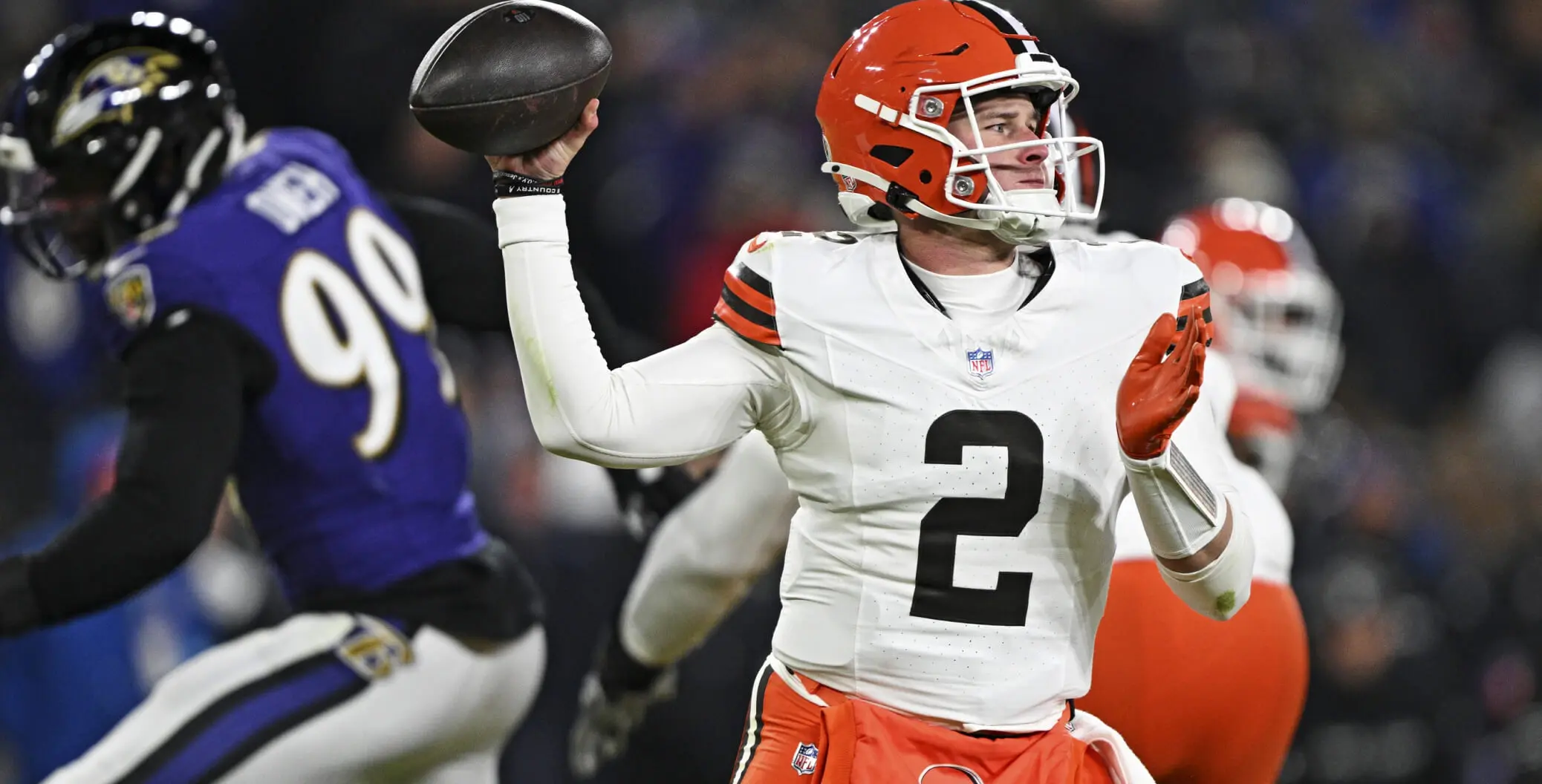 Cleveland Browns quarterback under pressure from Baltimore Ravens defender during NFL game