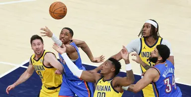 Indiana Pacers and Oklahoma City Thunder players battling for a rebound during an NBA game